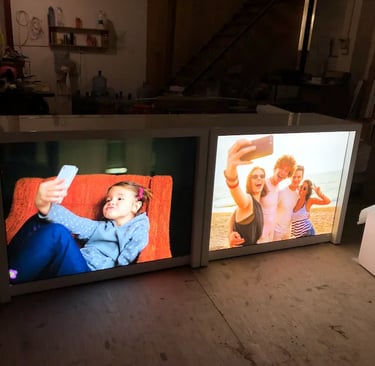 Backlit fabric light box displays featuring high-resolution lifestyle graphics in a warehouse setting.