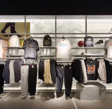 Jordan brand apparel and accessories displayed on retail clothing racks in a modern sports store.