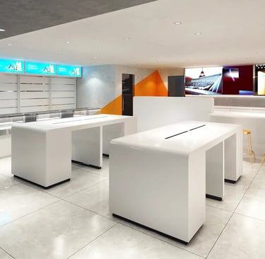 Modern white minimalist mobile phone store interior with sleek display tables and digital signage.