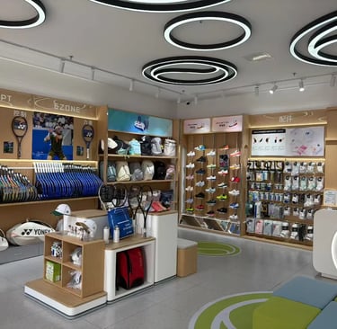 Yonex tennis retail store featuring professional rackets, sports apparel, and athletic footwear displays.