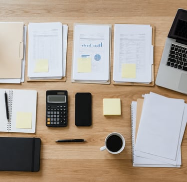 Organized business paperwork and office tools arranged neatly on a desk.