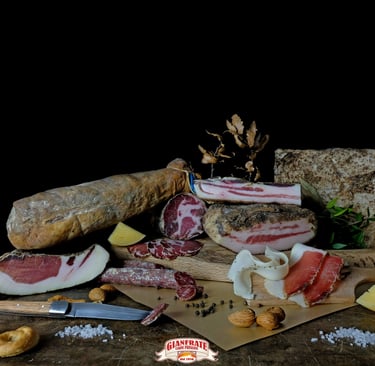 Selection of Italian cured meats like capicola and pancetta with cheese on a rustic board.