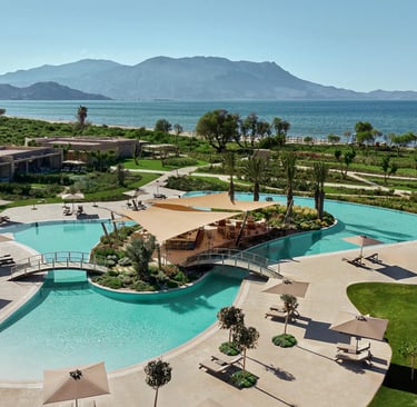 Deluxe swimming pool at Ikos Kissamos and mountains in the background.