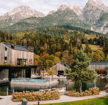 Luxury mountain resort with outdoor heated pool and wooden chalets nestled in the Alps.