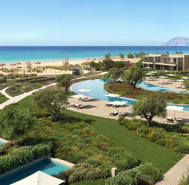 Luxury Ikos resort with turquoise pools, modern villas, and ocean views in a coastal landscape.