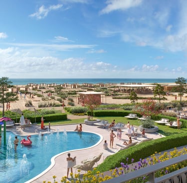 Cavallino Bianco Family Resort, Caorle, Italy swimming pool and beach with sunbeds
