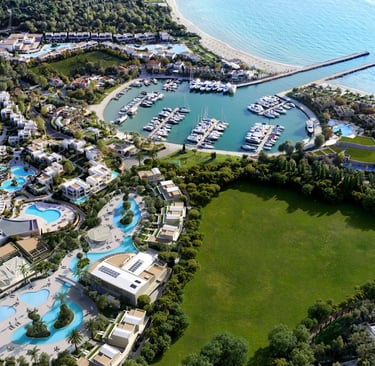 Aerial view of Porto Sani featuring a private marina, turquoise swimming pools, and white villas.
