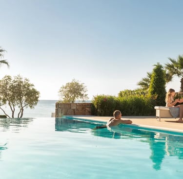 A family relaxes by a luxury infinity pool at Sani overlooking the Mediterranean 