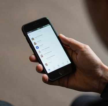 Close-up photo of a sleek modern smartphone on a wooden desk surrounded by tech gadgets.