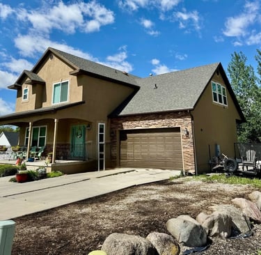 house with brown studdo and brown earth tones manufactured stone veneer prior to exterior remodel