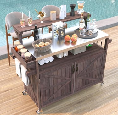 Rustic wood rolling bar cart with a stainless steel top and storage, stocked with drinks by a swimming pool.