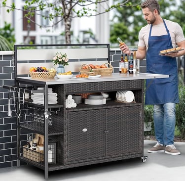 A man uses a mobile outdoor kitchen island cart with storage for grilling and backyard entertaining.
