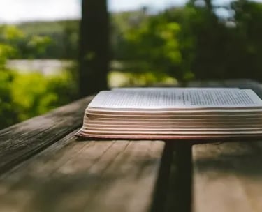 a book sitting on top of a wooden table showing bible answers