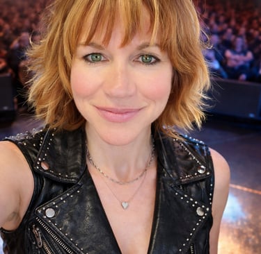 Tracy wearing a studded leather vest at a concert.