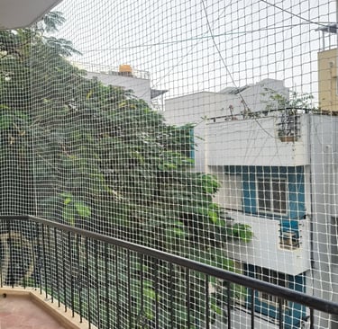 Technician from Sukumari Safety Nets carefully measuring a window frame for net installation.