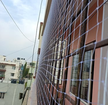 Close-up of a securely installed balcony safety net on a Sarjapura Road apartment.