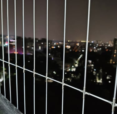 Installation process snapshot capturing careful mounting of invisible grills on a residential balcon