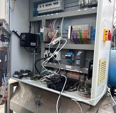 Industrial electrical control panel with PLC, circuit breakers, and wiring for automated systems.