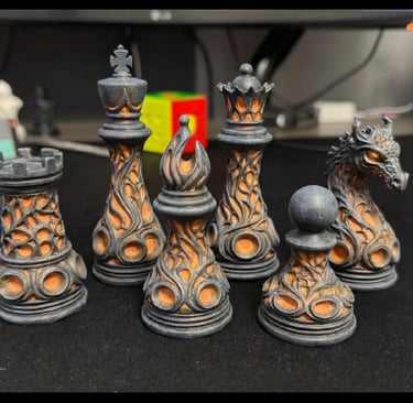 Custom 3D printed fantasy chess set featuring dragon and gothic flame designs in grey and orange.