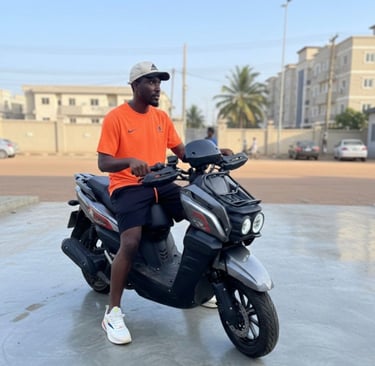 young man on orange tshirt on a gray and black bike