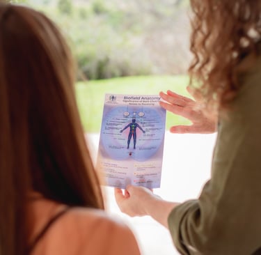 Sheila Doerfler showing the Biofield Anatomy Map to a client
