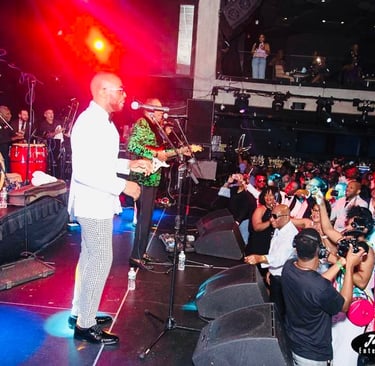 Clinton Benoit standing on a stage with a microphone at the Melrose Ballroom in Long Island City