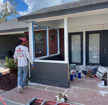 Professional painter prepping a residential front porch for a modern exterior house painting project.