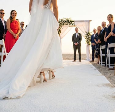 beach wedding with white artificial turf so the brides heels dont sink
