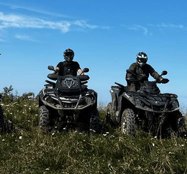 a group of people riding on four wheelers