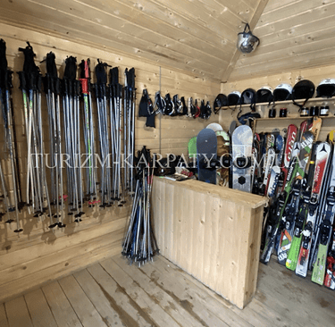 a room with a bunch of skis and snowboards