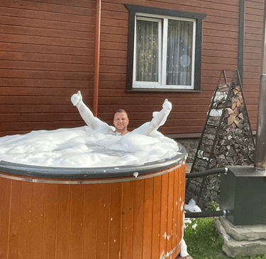 a man in a hot tub with foam foams