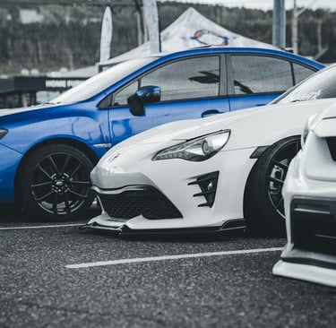 3 cars parked on black turf