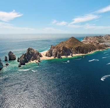 a group of boats sailing in the ocean