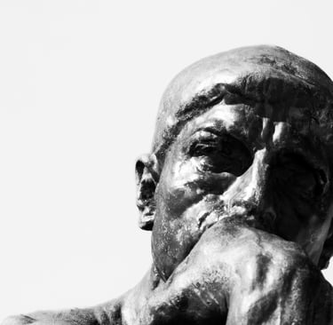 Rodin's The Thinker bronze statue head and hand.