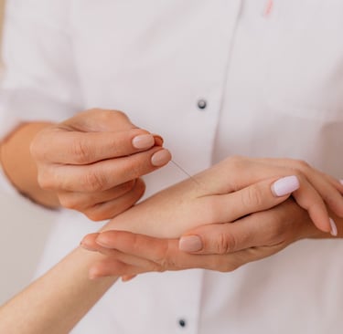 Close-up of a practitioner performing hand acupuncture therapy for holistic pain relief.