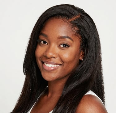 A smiling woman holding a tablet showing digital clipart designs in soft pastel colors.