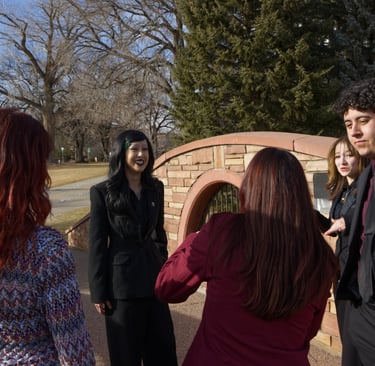 Image of the Quesada-Stoner Gregg teams standing in a circle. All looking at Quesada-Stoner.