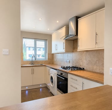 Bright kitchen with cream cabinets, wood countertops, gas hob, fitted in Littlemore
