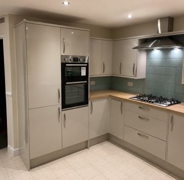 Modern kitchen with glossy grey cabinets, a built-in double oven, gas hob, fit in Kidlington