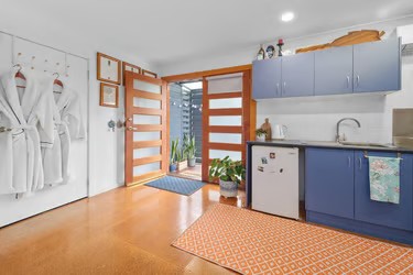 View of the cosy Artist Studio room at Marché Nude Stay with French doors opening to the kitchenette.