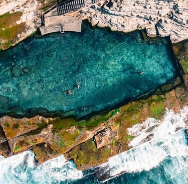 A historic ocean pool carved into the rocks, just a short drive from Marché Nude Stay.