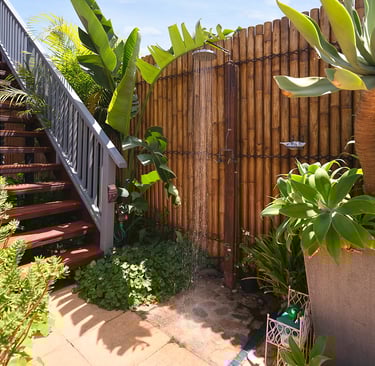 Outdoor shower and stairs leading to the accommodation at Marché Nude Stay.