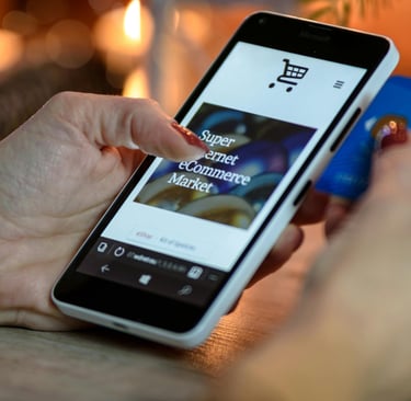 A person using a smartphone and credit card for mobile online shopping at an ecommerce store.