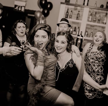 1920s themed murder mystery party. Lots of people are dressed up in a bar.