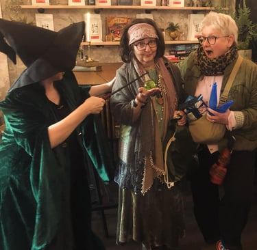 three women at a Harry Potter themed quiz. one looks shocked.