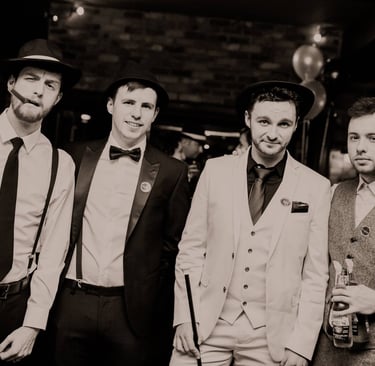 four men dressed in 1920s outfits at a murder mystery.