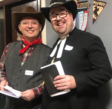Two men dressed up for a Wild West cowboy murder mystery.