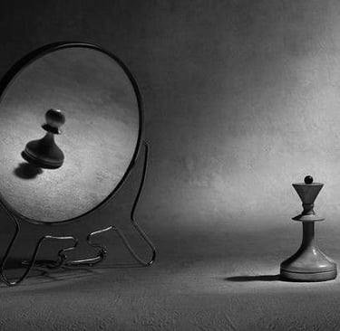 chess pieces and mirror as analogy for self-doubt