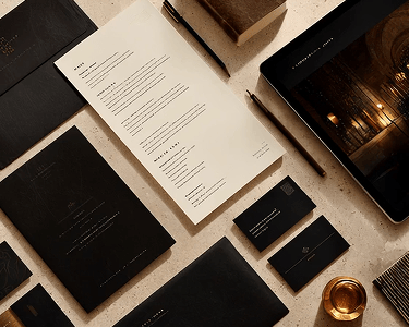 An assembly of brand assets live flyers, business cards and others carefully laid out on a table.