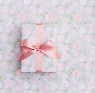 a gift wrapped in pink ribbon and tied with a pink ribbon
